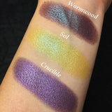 Top angled arm swatches on fair skin tone of Wormwood Duochrome Eyeshadow compared to Sol, Crucible 