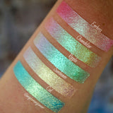 Right angled arm swatches on medium skin tone of Emboss Glitter Multichrome Eyeshadow shifts compared to Chandelier, Ripple, Sunbeam, Ciel