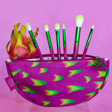 Front view of Dragon Fruit Brush set sticking out from Dragon Fruit Cosmetic Bag