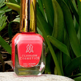 Blossom Nail Lacquer bottle in front of greenery.