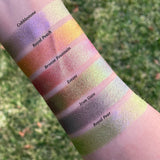 Top angled arm swatches on fair skin tone of Estate Earth Vibrant Multichrome Eyeshadow shifts compared to Cobblestone, Royal Peach, Bronze Fountain, Iron Gate and Royal Pear