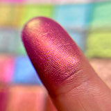 Close up finger swatch of Cinder Electric Multichrome Pigment on fair skin tone