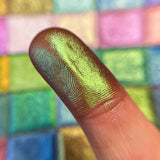 Close up finger swatch on fair skin tone of Citron Deep Iridescent Multichrome Eyeshadow