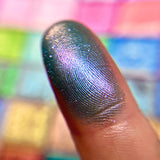 Close up finger swatch on fair skin of Climbing Vine Earth Vibrant Multichrome Eyeshadow