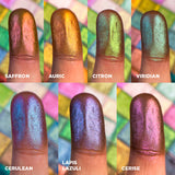 Close up finger swatches on fair skin of Saffron, Auric, Citron, Viridian, Cerulean, Lapis Lazuli and Cerise Deep Iridescent Multichromes