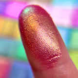 Close up finger swatch on fair skin tone of Empress Glitter Vibrant Multichrome Eyeshadow