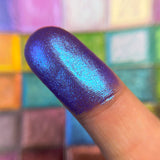 Close up finger swatch on fair skin tone of Etched Glitter Multichrome Eyeshadow