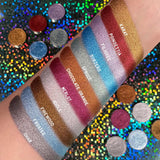 Top angled are swatches on fair skin tone of The Ultra Metals Collection including Chocolate Orange Foiled Eyeshadow  next to Karat, Poinsettia, Filigree, Subzero, Spruce, Merlot, Icicle, Firewood, Frosted, Char