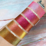 Top angled arm swatches on fair skin tone fo Left angled arm swatches on fair skin tone of Engrave Glitter Multichrome Eyeshadow shifts compared to Emboss, Torch, Blaze, Foiling