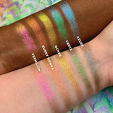 Top angled arm swatches on deep and fair skin tone of Ochre Deep Iridescent Multichrome Eyeshadow shifts compared to Azure, Verte, Burnt Sienna, Vermilion