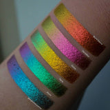Right angled arm swatches fair skin tone of Vermilion Deep Iridescent Multichrome Eyeshadow shifts compared to Azure, Verte, Ochre, Burnt Sienna