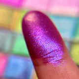 Close up finger swatch on fair skin tone of Flashed Glass Electric Multichrome Pigment