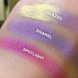 Bottom angled close up hand swatches on fair skin tone of Enamel Glitter Multichrome Eyeshadow shifts compared to Glazed, Spotlight
