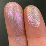 Close up finger swatches on fair skin tone of Glazed Glitter Multichrome Eyeshadow