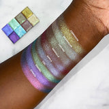 Top angled arm swatches on deep skin tones of partial Glitter Multichrome Bundle including Corrosion, Chandelier, Carving, Grisaille, Ripple, Ciel, Enamel, Stencil