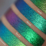 Close up right angled arm swatches on fair skin tone of Anneal Jewelled Multichrome Eyeshadow shifts compared to Castle, Trefoil