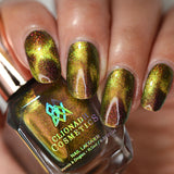 Close up of nails done with Hazard Nail Lacquer featuring a design to show off the magnetic effect on medium skin tone.