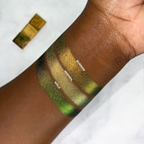 Arm swatches of Jewelled Multichromes Weld, Vermeil and Burnish on deep skin.
