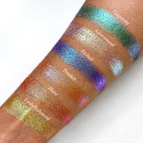 Top angled arm swatches on medium skin tone of Trinket Glitter Multichrome Eyeshadow shifts compared to Flagstone, Adornment, Etched, Flare and Embellishment