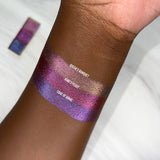 Top angled arm swatches on deep skin tone of Coat of Arms Hybrid Multichrome Eyeshadow shifts compared to Queen's Banquet and King's Feast