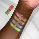 Top angled arm swatches on deep skin tone of Coronation Vibrant Multichrome Eyeshadow shifts compared to Monarch, Reign and Topiary