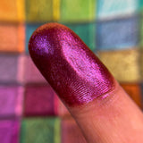 Close up finger swatch on fair skin tone of King's Feast Hybrid Multichrome Pigment