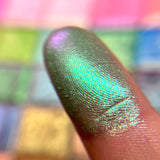 Close up finger swatch on fair skin tone of Motif Electric Mulitchrome Eyeshadow