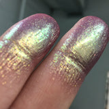 Close up low angled finger swatches on fair skin tone of Opulent Glitter Multichrome Eyeshadow