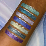 Top angled arm swatches on deep skin tone of Nocturnal compared to Spruce, Necromancer, Filigree, Aqua Vitae, Narwhal and Crucible