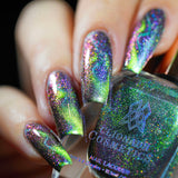 Close up of nails done with Psychonaut Nail Lacquer featuring a design to show off the magnetic effect on fair skin tone