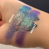 Close up hand swatches on fair skin tone of Regal Vibrant Glitter Multichrome Eyeshadow compared to Royalty Vibrant Multichrome Eyeshadow
