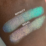 Close up hand swatches on deep skin tone of Regal Vibrant Glitter Multichrome Eyeshadow compared to Royalty Vibrant Multichrome Eyeshadow