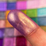 Close up finger swatch on fair skin tone of Renaissance Pearlescent Multchrome Eyeshadow