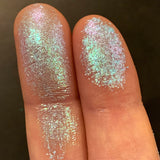 Close up finger swatches on fair skin tone of Ripple Glitter Multichrome Eyeshadow