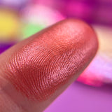 Macro finger swatch of Strawberry Pear on fair skin tone