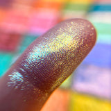 Close up finger swatches on fair skin tone of Sunbeam Glitter Multichrome Eyeshadow.