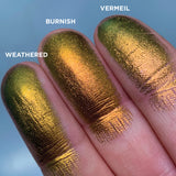 Top angled finger swatches on fair skin tone of Burnish Jewelled Multichrome Eyeshadow shifts compared to Vermeil, Weathered
