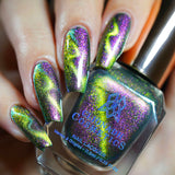 Close up of nails done with Toxic Sludge Nail Lacquer featuring a design to show off the magnetic effect on fair skin tone