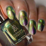 Close up of nails done with Toxic Sludge Nail Lacquer featuring a design to show off the magnetic effect on medium skin tone