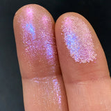 Close up finger swatches on fair skin tone of Translucency Glitter Multichrome Eyeshadow