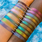 Top right angled arm swatches on fair and deep skin tones of Regal Vibrant Glitter Multichrome Eyeshadow featured in Undiscovered Eyeshadow Bundle