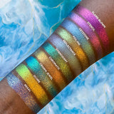 Top right angled arm swatches on deep skin tone of Regal Vibrant Glitter Multichrome Eyeshadow featured in Undiscovered Eyeshadow Bundle