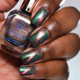 Close up of nails done with Psilocybin Nail Lacquer featuring a line to show off the magnetic effect on deep skin tone