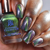 Close up of nails done with Psychonaut Nail Lacquer featuring a design to show off the magnetic effect on deep skin tone.