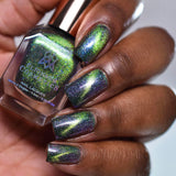 Close up of nails done with Psychonaut Nail Lacquer featuring a line to show off the magnetic effect on deep skin tone