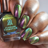 Close up of nails done with Toxic Sludge Nail Lacquer featuring a design to show off the magnetic effect  on deep skin tone.