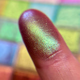 Close up finger swatch on fair skin of Wall of Ivy Earth Vibrant Multichrome Eyeshadow