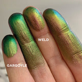 Left angled finger swatches on fair skin tone of Gargoyle Jewelled Multichrome Eyeshadow shifts compared to Weld