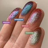 Right angled finger swatches on fair skin tone of Toadstool Duochrome Eyeshadow compared to Abrasion, Wormwood, Grisaille 