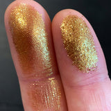 Close up finger swatches on fair skin tone of Foiling Glitter Multichrome Eyeshadow